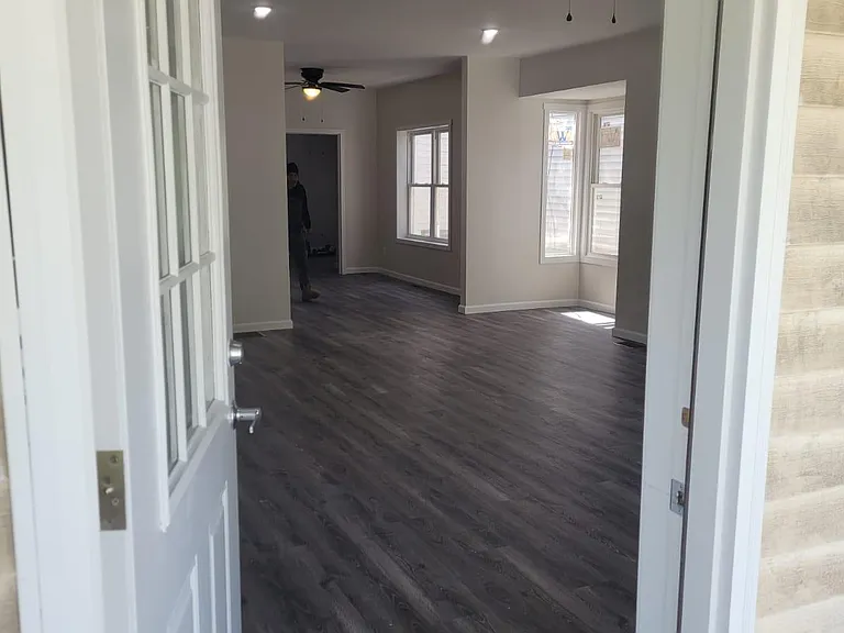 Large porch leads into the bright and airy two-story apartment.