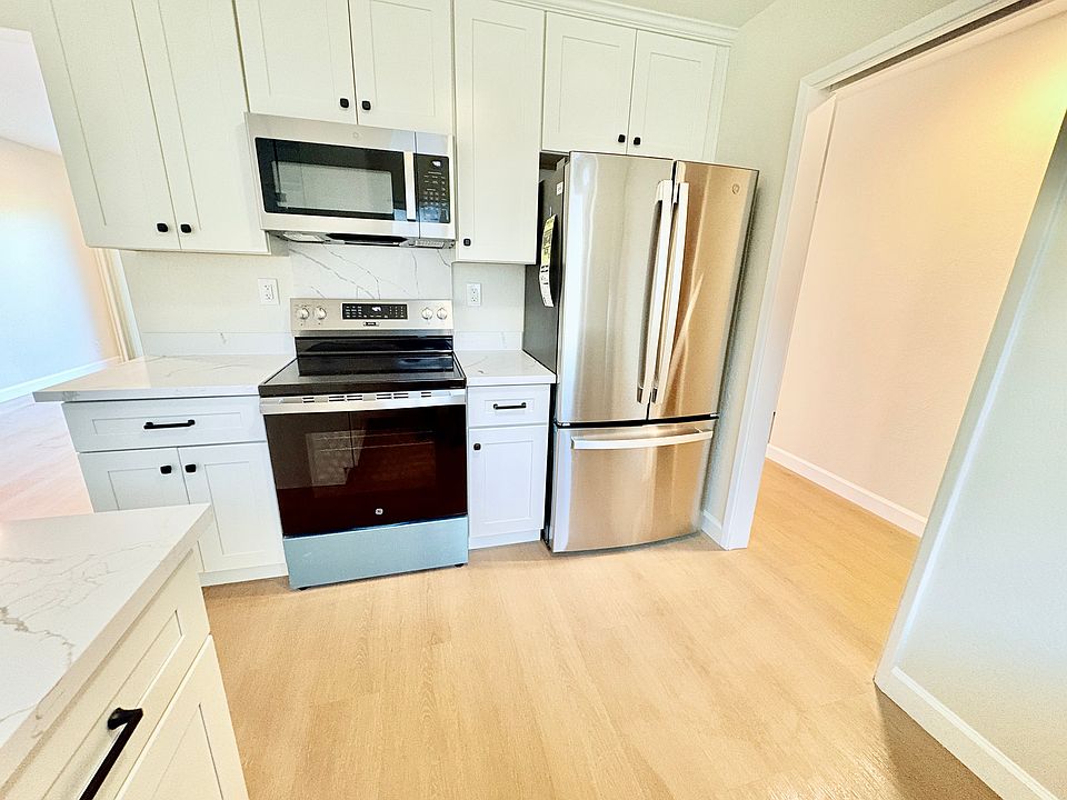 New cabinets, microwave, oven, refrigerator, floor, paint, lights windows