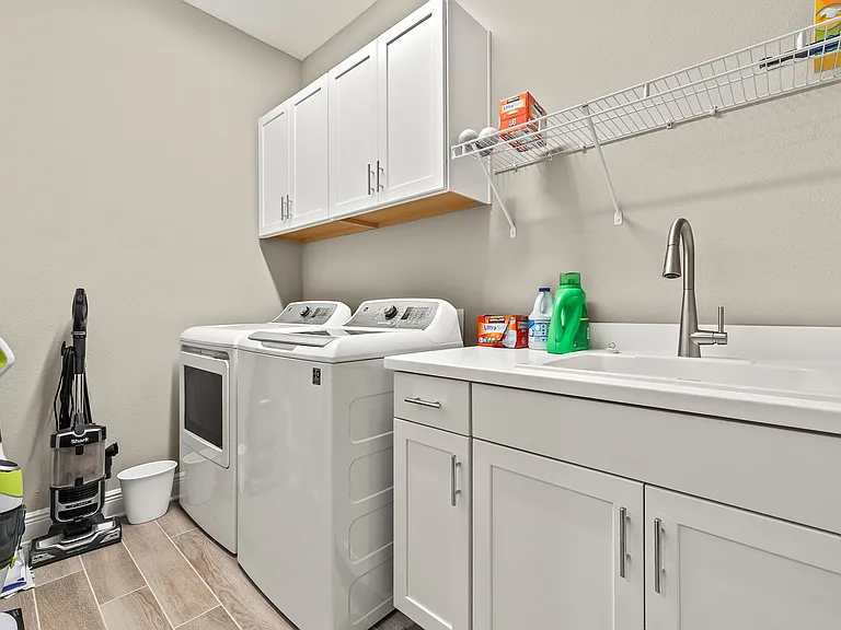 Upper & Lower Cabinetry & large laundry sink.