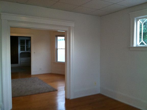 View of living room towards dining room with built in antique china cabinet.