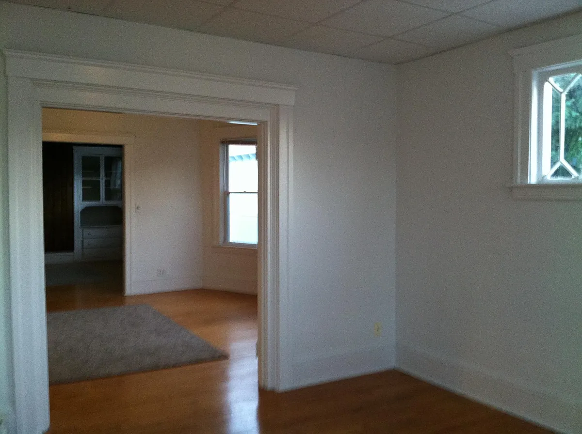 View of living room towards dining room with built in antique china cabinet. - 120 Elm St #3