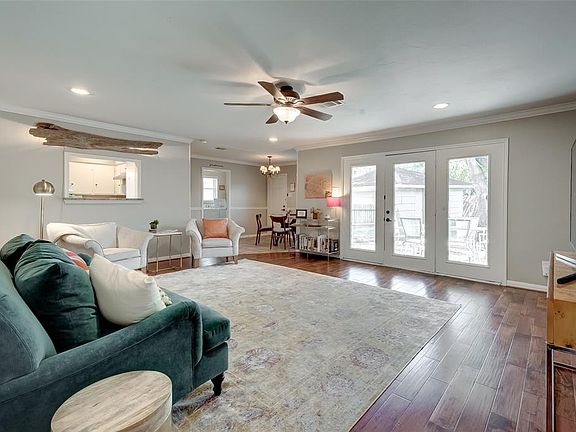 View of the Den from the Entryway. Lots of Natural Light comes through your Big Windows. Nobody is left out of the conversation with the cut out in the Kitchen.