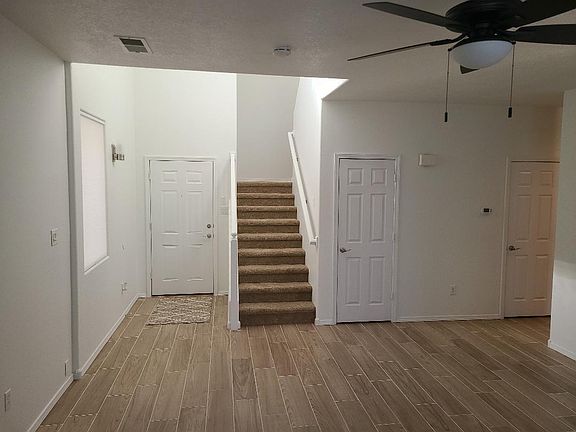 Front entry, stairway, strorage closet, half bath door