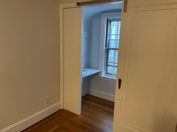 Small closet office space off the large living room with laptop/desk top space. This closet office has a sliding barn door for privacy when working from home on a Zoom Call.