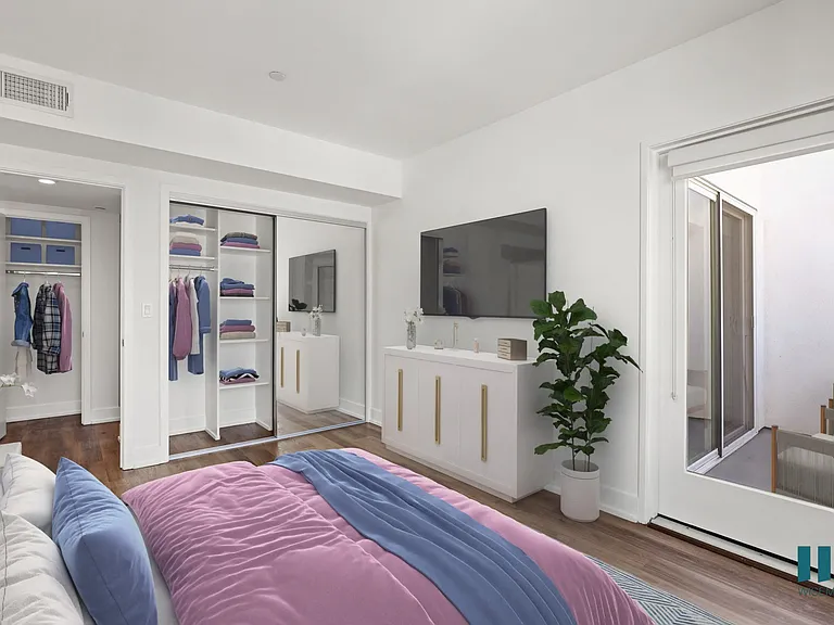 Bedroom with Mirrored Closet with Shelving, Vinyl Flooring, and Patio
