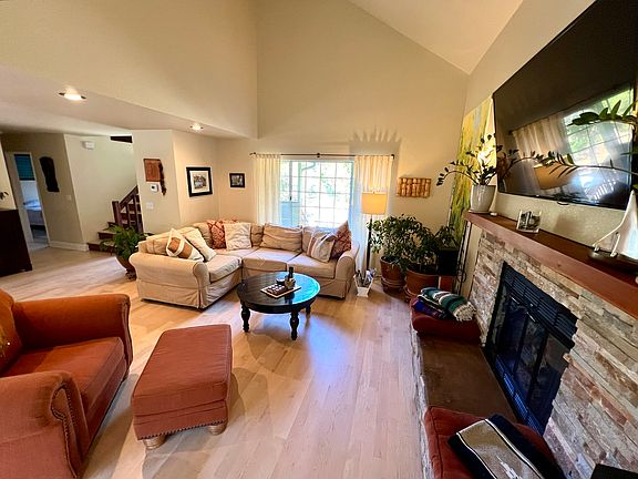 Very cozy living room, with staircase to second floor in the back right of photo