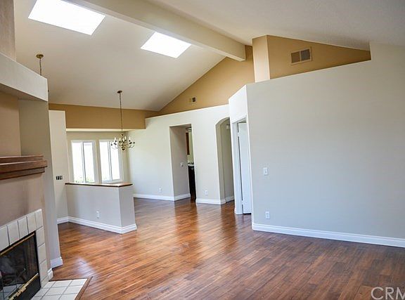 Open floor space.  Note sky lights, vaulted ceilings and fireplace