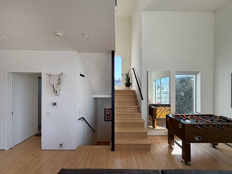 The stairs lead to the third level, a secluded owner's suite.