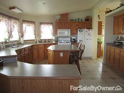 Large Kitchen! : Tile floor and many cabinets. Large pantry area with shelves.