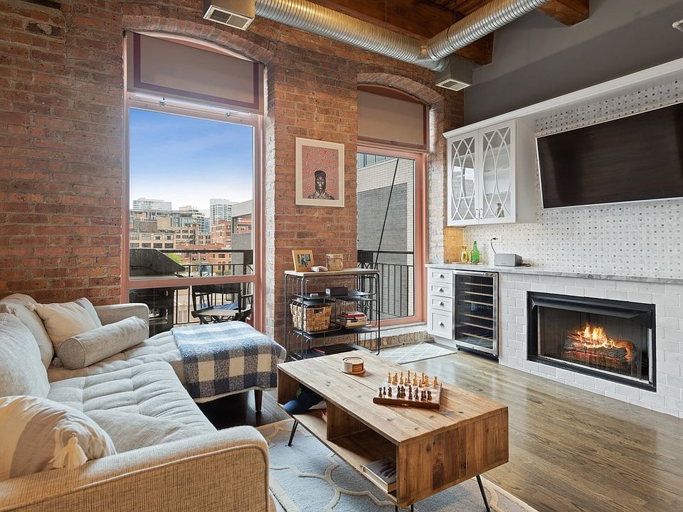 Beautiful living space with natural light and a cozy fireplace.