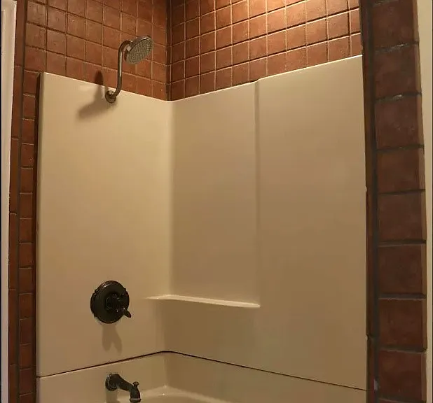 The shower in the bathroom closest to the room