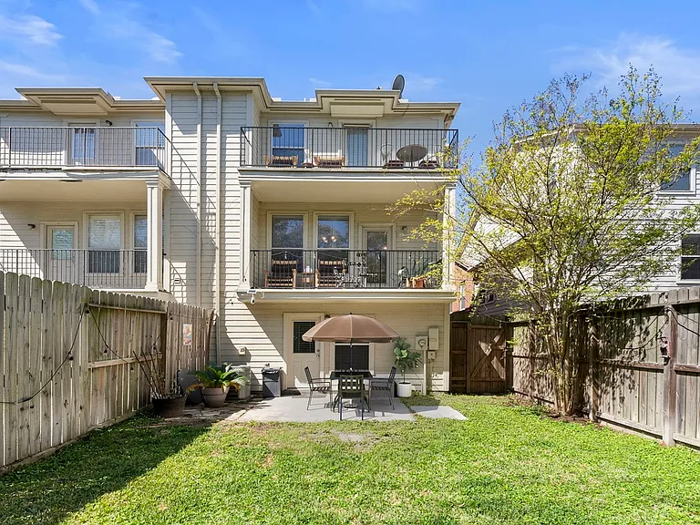 Backyard with shared 2nd floor balcony. Furnishings are staged