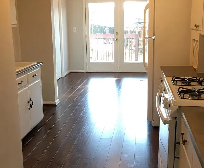 Spacious kitchen with gas stove, built-in microwave, fridge, dishwasher, garbage disposal, and pantry
