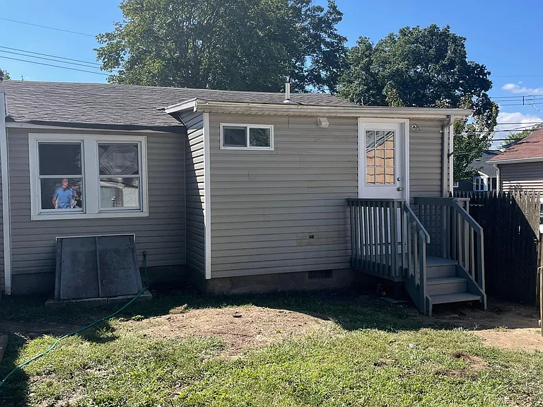 rear of property with fenced in backyard