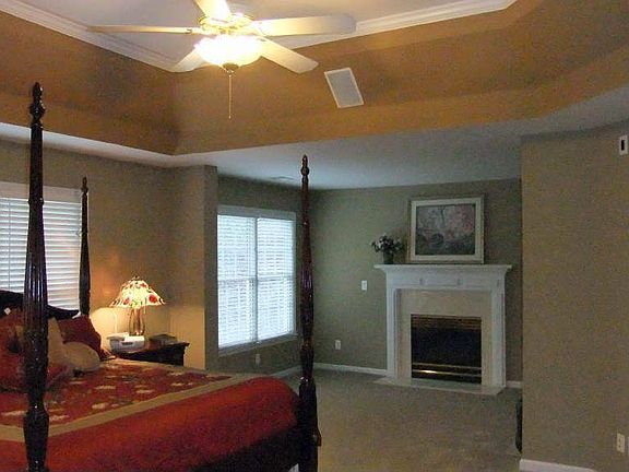 Master Bedroom with trey ceiling, ceiling fan and Sitting Area with Fireplace