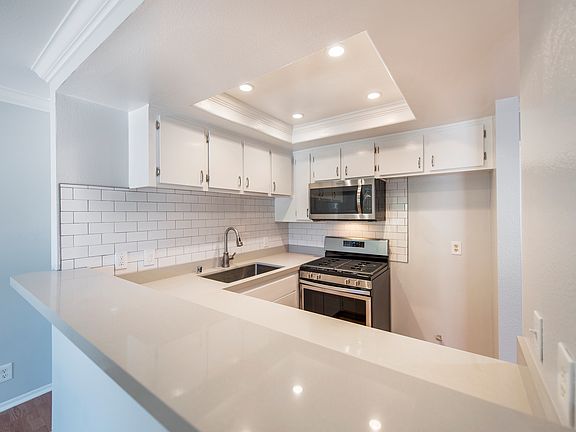 Remodeled kitchen with subway tile, quartz counters, stainless appliances (photo was pre refrigerator but unit now has included refrigerator.