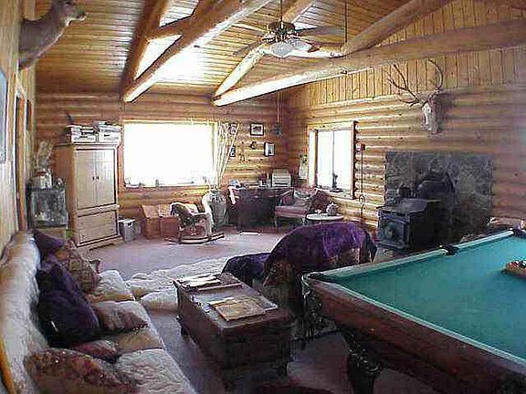 Cozy wood stove with plenty of firewood.