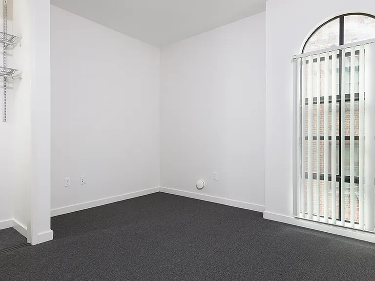 Spacious bedrooms at Bachenheimer Apartments with oversized arched windows