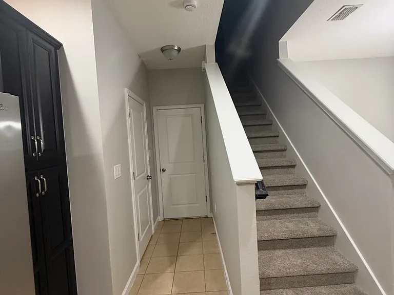 Staircase and downstairs half bath.