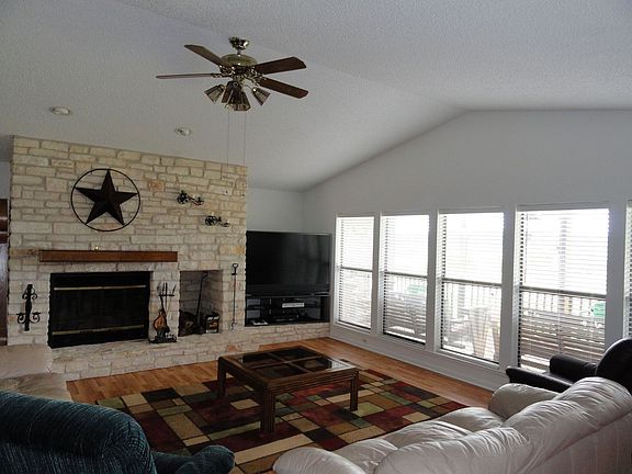 Large open living room with high ceilings and brick fireplace