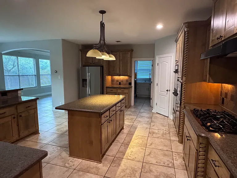 Large kitchen with granite countertops and gas cooktop