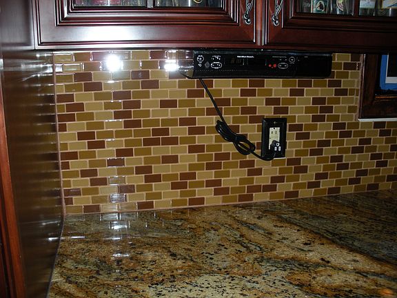 Kitchen with granite countertop and glass mosaic tile backsplash