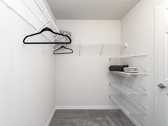 Roomy walk-in wardrobe - New home for sale in Lakelan, FL. Photo showcases the home layout - colors