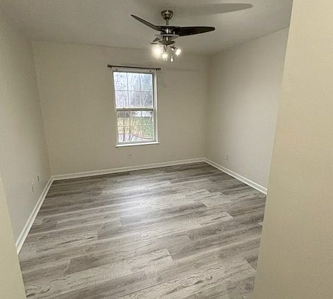 Bedroom with freshly painted walls and LVP floors