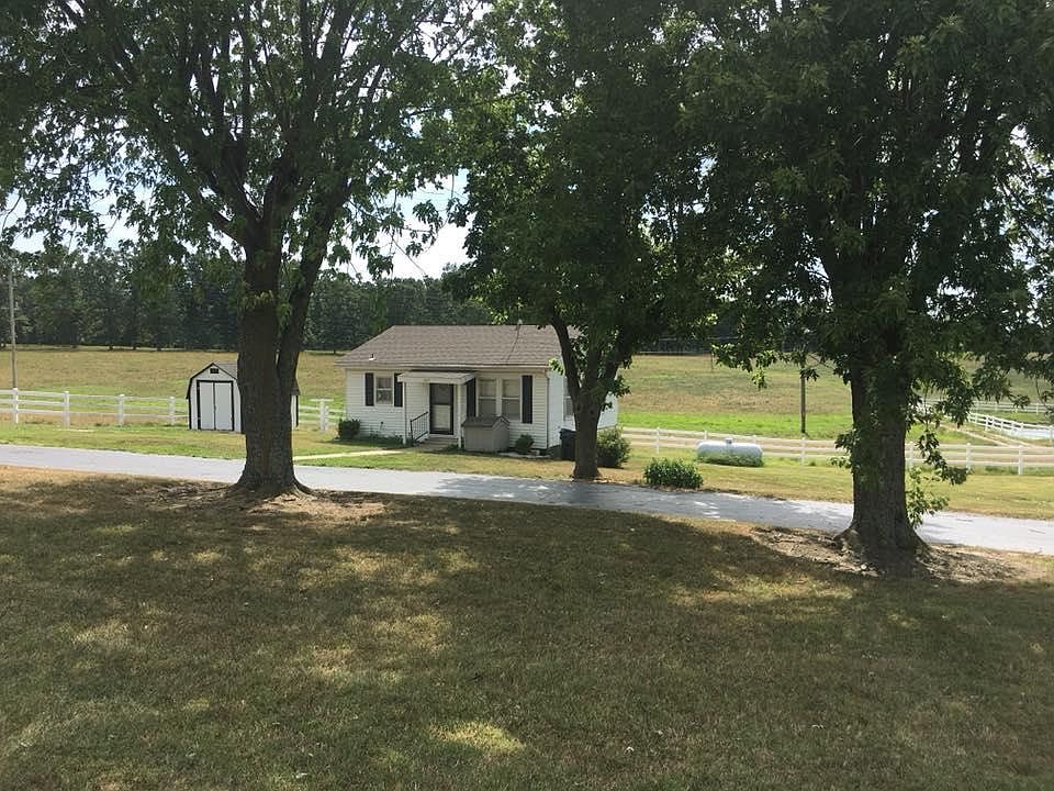 Cute little farm home and 8x12 shed with circle driveway.