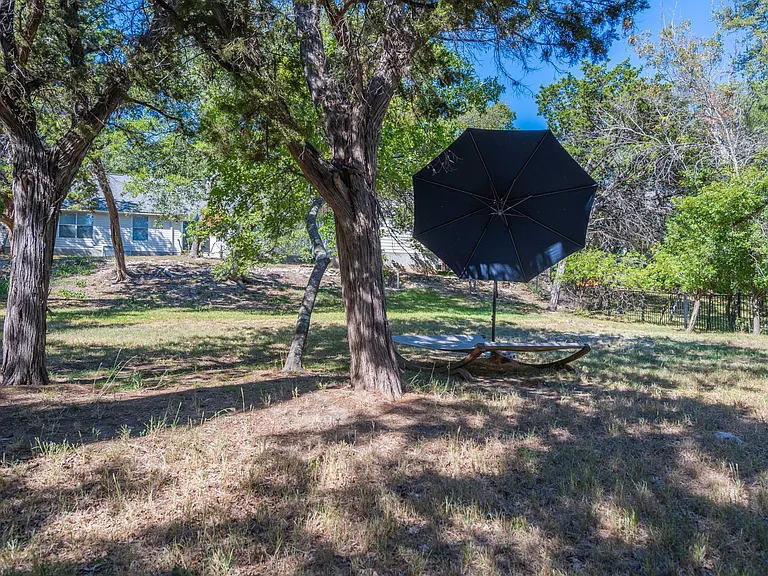 Hammock under an oak tree in the backyard.
