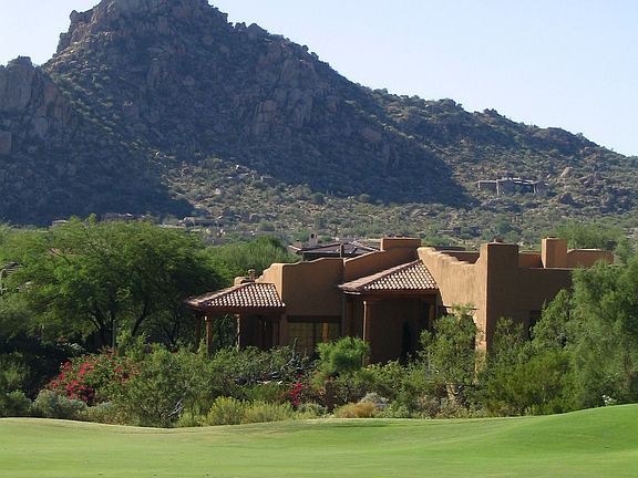 view of home from fairway with pinnacle peak