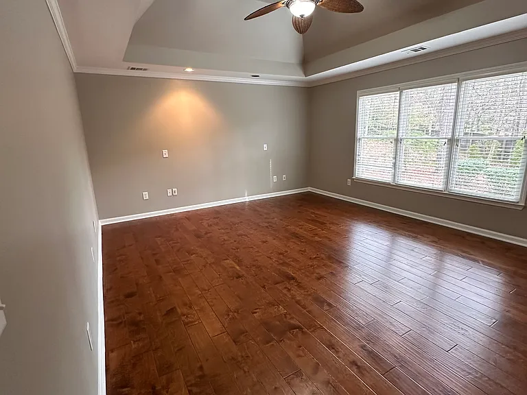 Welcome to your large Master Bedroom with Trey Ceiling! Look out over your private patio and backyard.
