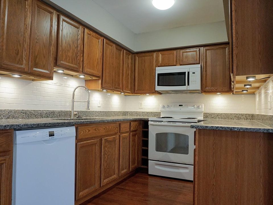 Enjoy your new kitchen with granite countertops, under cabinet lighting and newer appliances, including a brand new Bosch dishwasher.