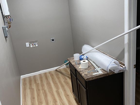 Washer and dryer hook and hallway with extra cabinet space