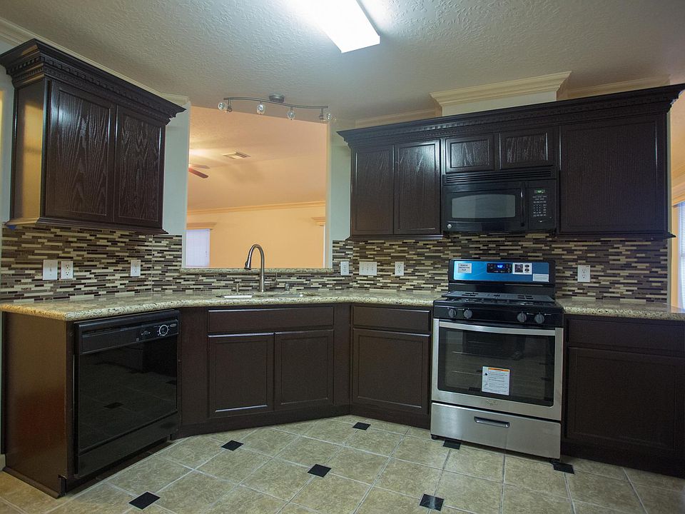 IIntricate kitchen cabinet design; brand new granite counter