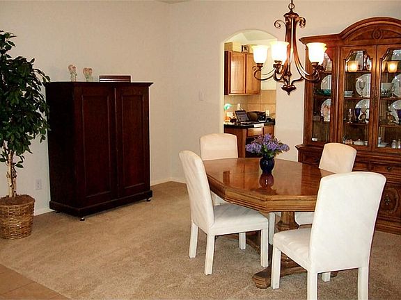 The Dining Room is located off the Foyer and is served conveniently by the Kitchen with upgraded iron chandelier and plenty of wall space