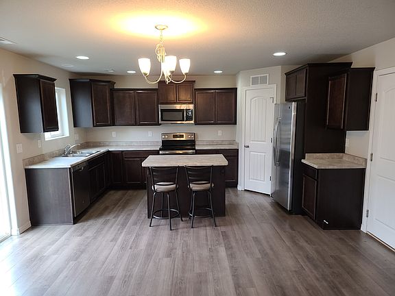 Spacious kitchen with stainless steel appliances, center island and walk in pantry.
