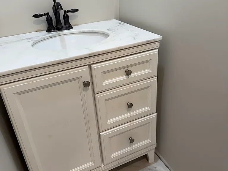 Half bath off of kitchen and hallway.
