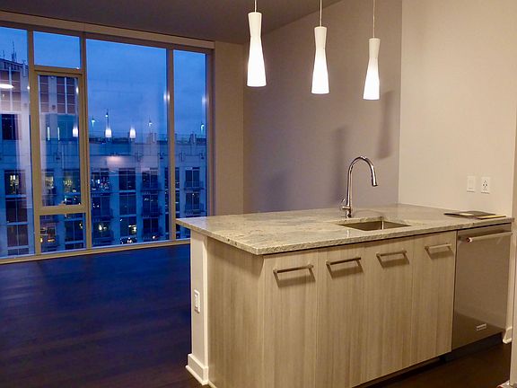 View East over kitchen island with dimmable pendant lamps