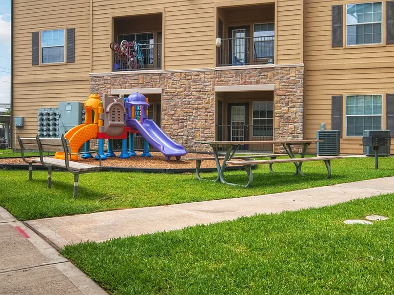 A playground with a slide at Stonehaven Apartments in Houston, TX