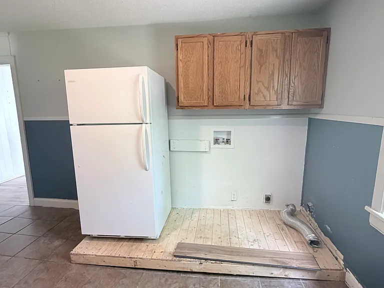 Fridge will be moved to left of platform. Platform is for washer and dryer.