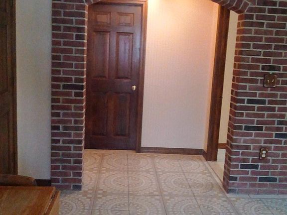 Living room  showing arch and hallway