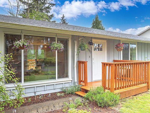 Picturesque front windows and porch lead you into this beautiful home.