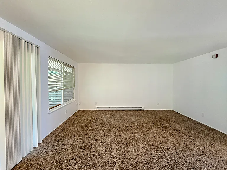 Bright living room with large window and plenty of natural light.
