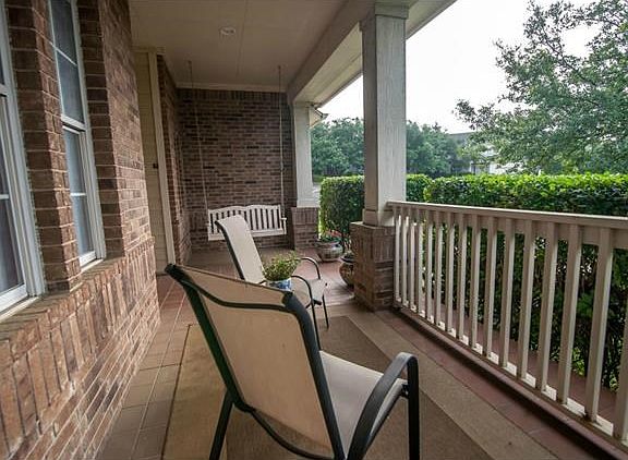Relax with a cool drink on the covered front porch.
