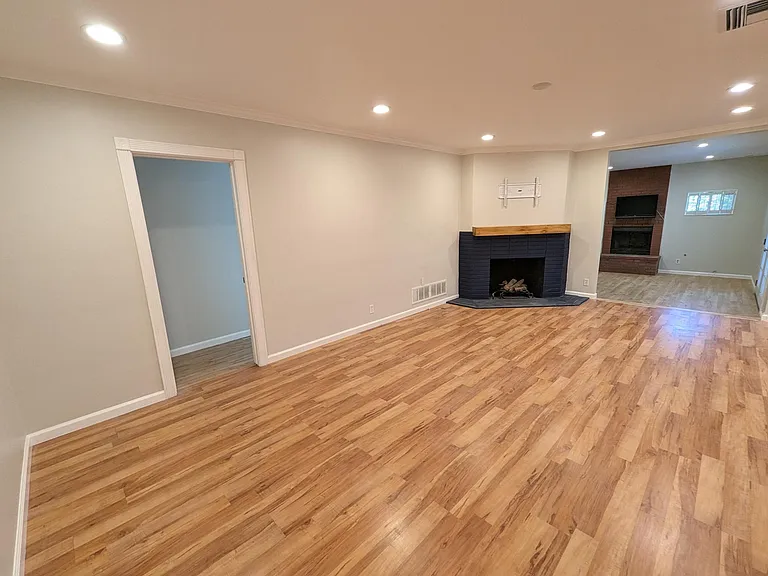 Step into the house and and you see the large living room and beautiful fireplace with built-in TV mount above