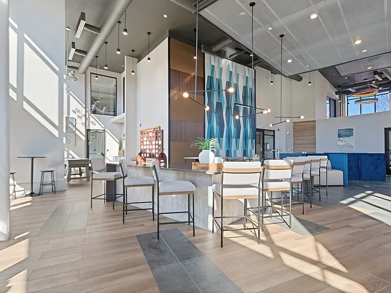 Entertaining bar and demo kitchen with waterfall counter host friends over drinks and games