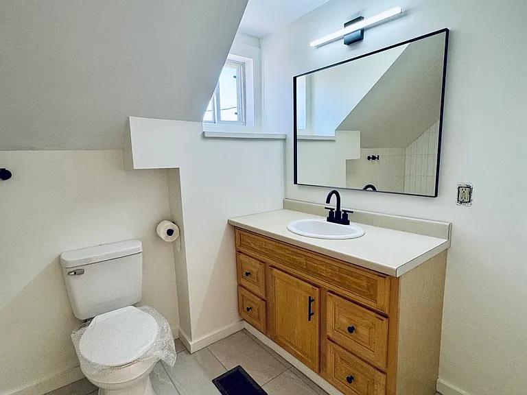 Bathroom with new tile, new toilet, new faucet and fixtures