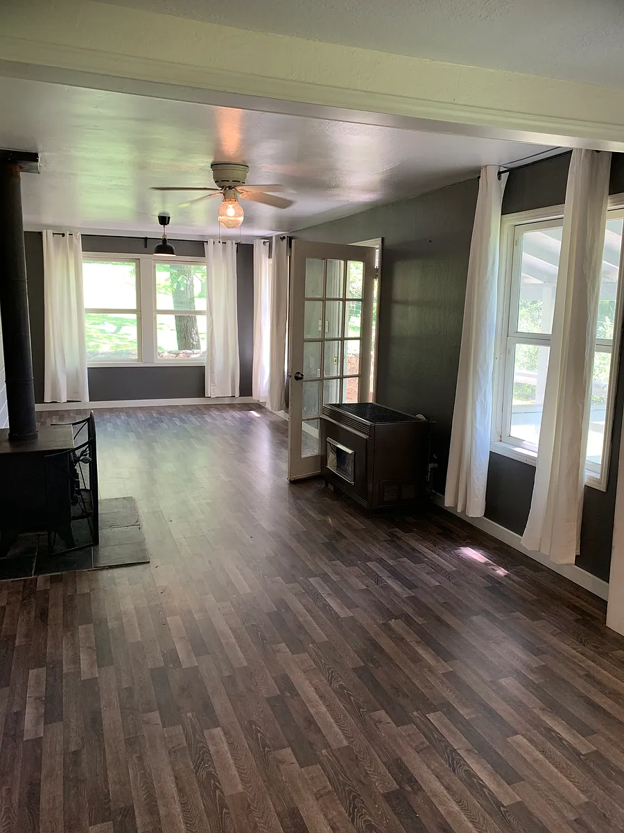 Wood stove and propane heater between the dining area and the living room - 12400 Mierkey Rd #3