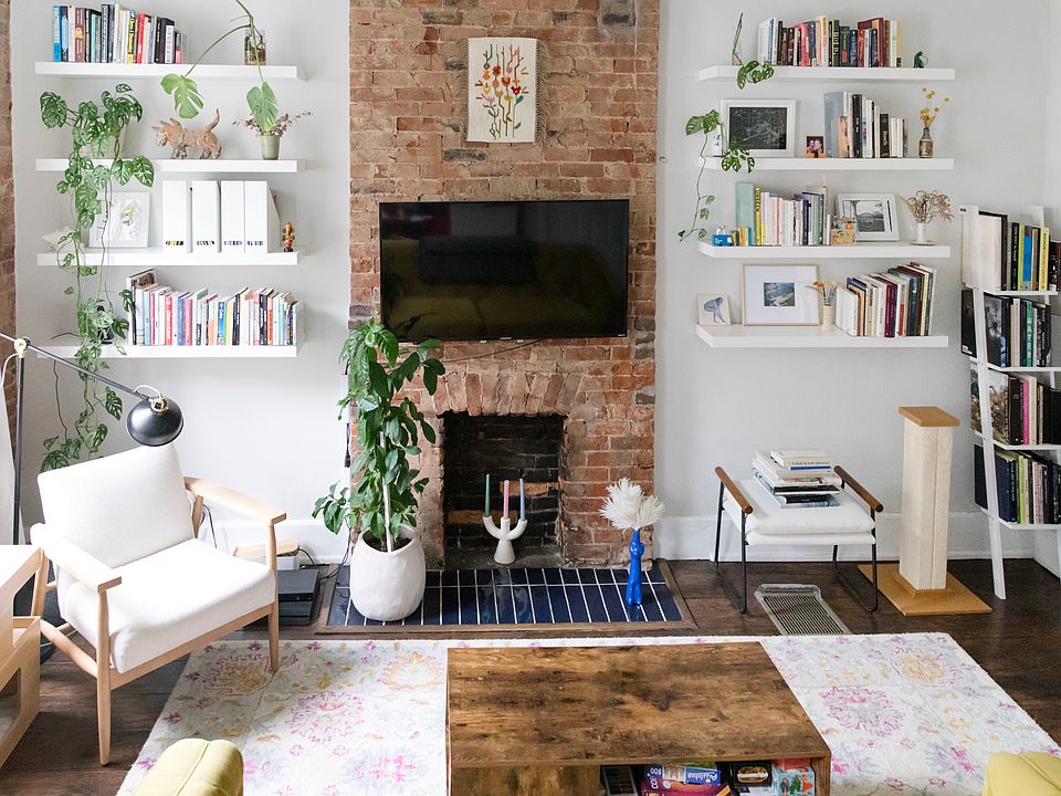 Bedroom/Living room facing front of street. Exposed brick and beautiful windows letting in tons of natural light. Smart thermostat and TV mount included.